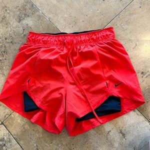 Orange Nike running shorts